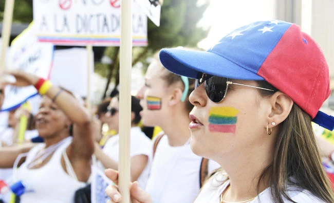 Venezuelan nationals and sympathizers with national flags painted on their faces protest in Madrid on Sunday against Venezuelan President Nicolas Maduro and the election of a Constituent Assembly the lastest in measures that have provoked numerous protests by the opposition aggravated the tension in a country polarized and plunged into a deep crisis, with brutal inflation and a serious shortage of food and medicines. (AFP)