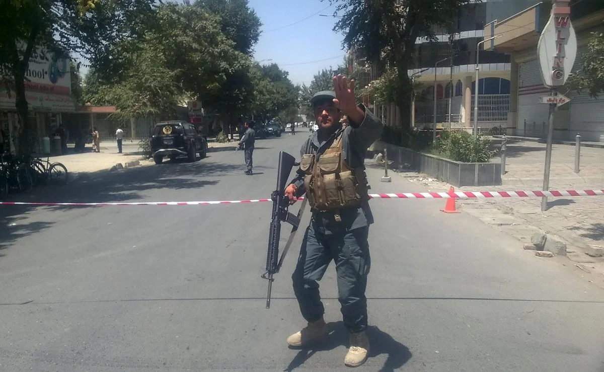 An Afghan policeman sets up a perimeter at the site of an explosion in Kabul on July 31, 2017. Afghan security sources said a suicide blast had hit the front of Iraq's embassy in the Kabul. (AFP)