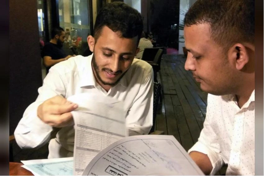 Yemeni Rafek Ahmed Mohammed Al-Sanani (R), 22, and Abdel Rahman Zaid, 26 look through documents as they speak with Reuters in Serdang, on the outskirts of Kuala Lumpur, Malaysia July 20, 2017. (REUTERS)