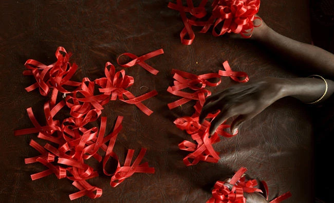 In this file photo taken on November 30, 2012 shows HIV positive women making red ribbons, the universal symbol of awareness and support for those living with HIV, at a support centre in Bangalore on the eve of World AIDS Day. Some 6,000 global HIV experts gather in Paris from July 23, 2017 to take stock of advances in AIDS science as fading hopes of unlocking a cure has shifted research into creative new fields. (AFP)