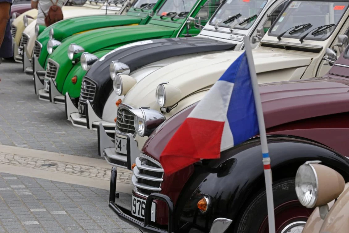 French flag is pictured in the parking area in Mafra after the parade of the World 2017 2CV Meeting July 30, 2017. The event is held between the 26th and the 31st of July 2017, 30 years after Portugal hosted the seventh 2CV World Meeting in 1987, and will include activities ranging from an open air fair, a competition to disassemble and reassemble, an "elegance" contest for original and modofied 2CV's, a chimes concert, to a short term 2CV museum hosted by the Marfa national palace featuring vehicles from the Citroen Heritage collection purposely brought from Paris. / AFP / JOSE MANUEL RIBEIRO