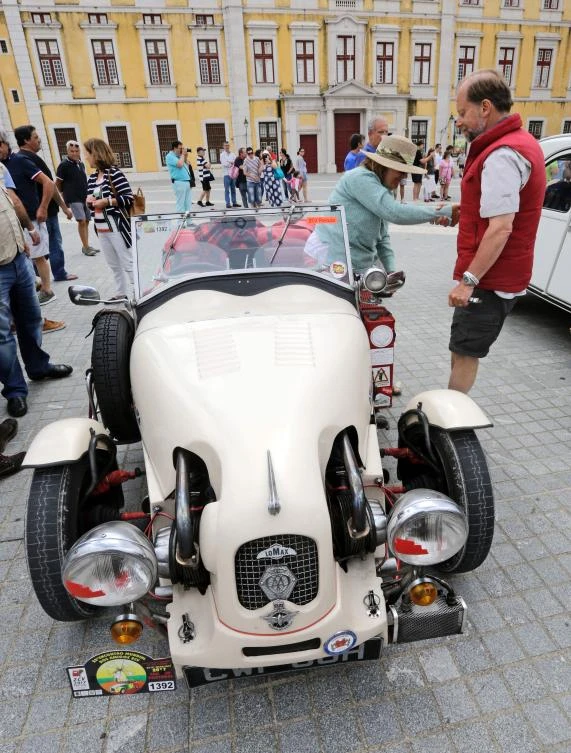 A participant helps his wife from a sport car 2CV version on the parking area in Mafra after the parade of Citroen classic cars 2CV during the World 2017 2CV Meeting July 30, 2017. The event is held between the 26th and the 31st of July 2017, 30 years after Portugal hosted the seventh 2CV World Meeting in 1987, and will include activities ranging from an open air fair, a competition to disassemble and reassemble, an "elegance" contest for original and modofied 2CV's, a chimes concert, to a short term 2CV museum hosted by the Marfa national palace featuring vehicles from the Citroen Heritage collection purposely brought from Paris. / AFP / JOSE MANUEL RIBEIRO