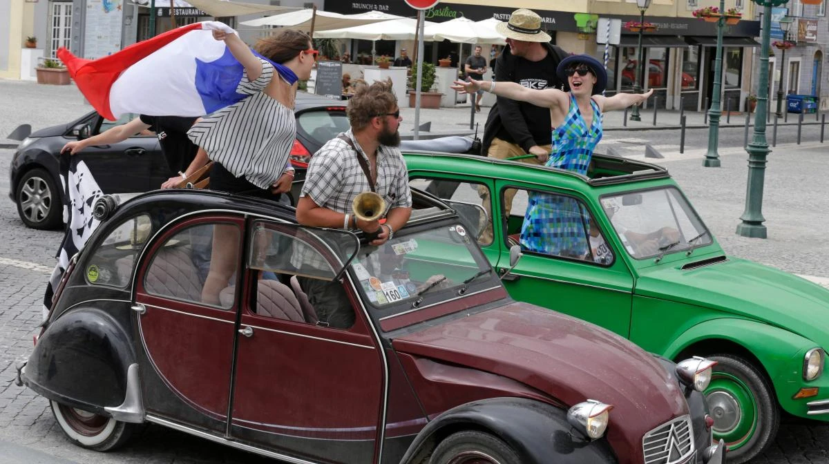 Participants stand in their vehicles during the parade of Citroen classic cars 2CV in Mafra during the World 2017 2CV Meeting July 30, 2017. The event is held between the 26th and the 31st of July 2017, 30 years after Portugal hosted the seventh 2CV World Meeting in 1987, and will include activities ranging from an open air fair, a competition to disassemble and reassemble, an "elegance" contest for original and modofied 2CV's, a chimes concert, to a short term 2CV museum hosted by the Marfa national palace featuring vehicles from the Citroen Heritage collection purposely brought from Paris. / AFP / JOSE MANUEL RIBEIRO