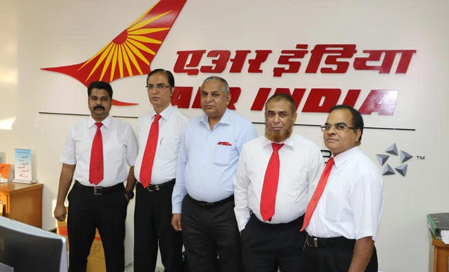Kundan Lal Gothwal, Air India manager, center, with AI staffers in Riyadh on Sunday.