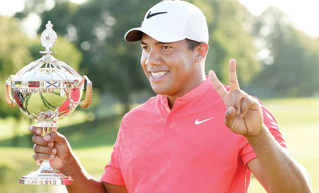 Jhonattan Vegas holds the winner's trophy as he poses for photos following his win at the final round of the 2017 Canadian Open at the Glen Abbey Golf Club in Oakville, Ontario, Sunday. (AP)