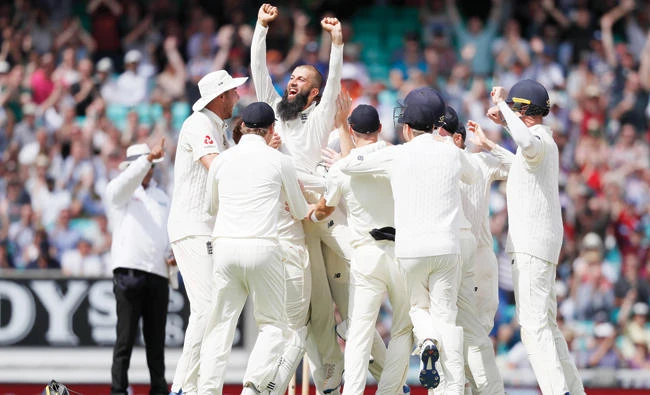 England’s Moeen Ali is lifted by his teammates after he scores a hat trick to get the wicket of South Africa’s Morne Morkel to win the Test match on the fifth day of the third match between England and South Africa at The Oval Monday. (AP)
