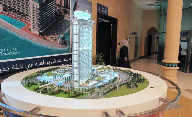 A woman walks next to a model of Nakheel Mall in Nakheel office in Dubai, United Arab Emirates, in this July 27, 2017 photo. (REUTERS)