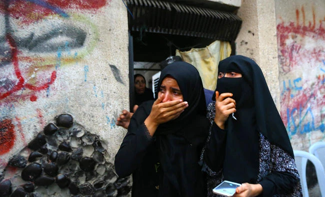 Palestinian relatives of a teenager who was shot dead by Israeli forces cry during his funeral in Gaza on Friday. (AFP)