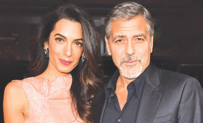 George Clooney and his wife Amal. (Reuters)
