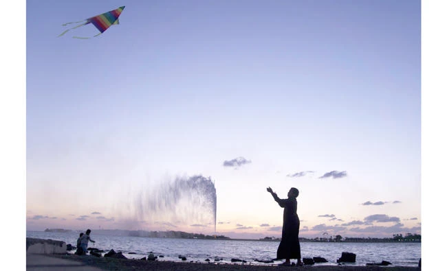 A boy flies a kite on the Red Sea beach near the landmark Jeddah fountain. (AP)