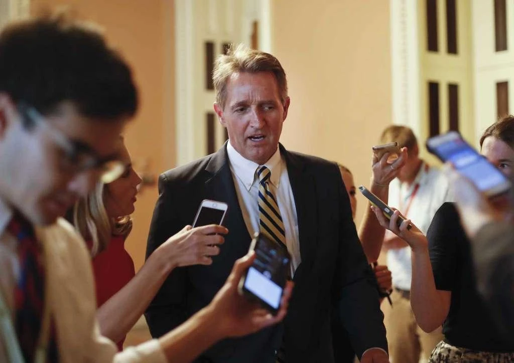 FILE - In this July 13, 2017, file photo, Sen. Jeff Flake, R-Ariz. speaks to members of the media as he walks to a meeting on Capitol Hill in Washington. There wasn’t a dramatic public break, or a precise moment when it happened. But little by little, Senate Republicans have been turning their backs on President Donald Trump. They’ve defied his Twitter demands, defeated his top agenda item and passed veto-proof sanctions on Russia over administration objections. Flake took aim at Trump and his own party in a new book, writing that “Unnerving silence in the face of an erratic executive branch is an abdication” and “the strange specter of an American president’s seeming affection for strongmen and authoritarians created such a cognitive dissonance among my generation of conservatives _ who had come of age under existential threat from the Soviet Union _ that it was almost impossible to believe.” (AP)
