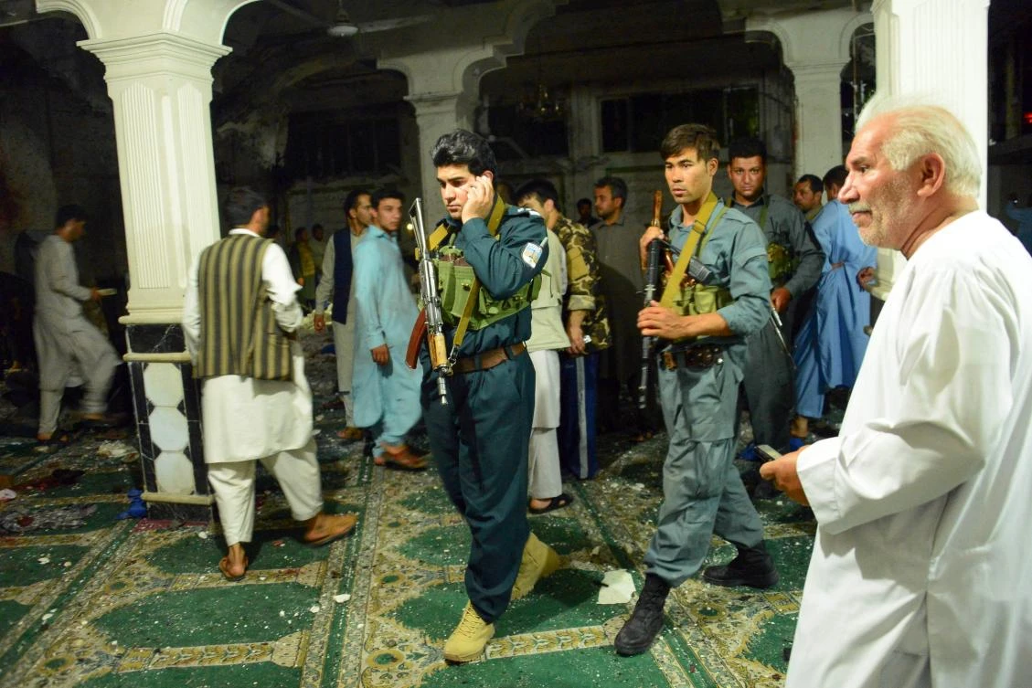 Afghan security personel inspect the site of a suicide bomb attack at a Shiite mosque in Herat on August 1, 2017. A suicide bomber and a gunman killed more than 20 people at a Shiite mosque in Afghanistan's main western city of Herat on August 1, the latest attack to highlight a deteriorating security situation in the country. (AFP)