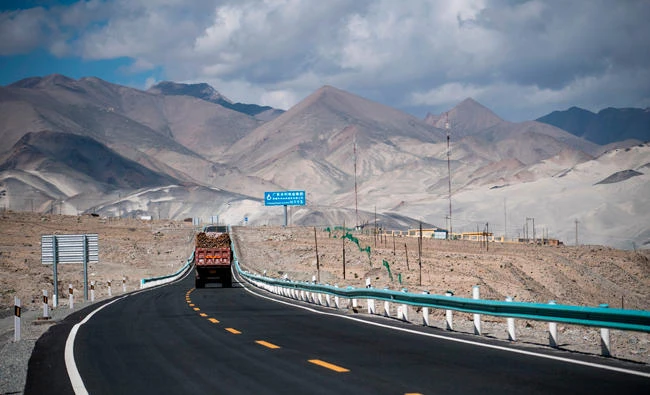 The file photo shows a truck is driving along the China-Pakistan Friendship Highway before the Karakorum mountain range near Tashkurgan in China's western Xinjiang province. (AFP)