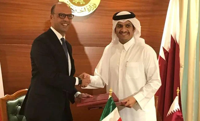 Italian Foreign Minister Angelino Alfano, left, shakes hands with Qatari Foreign Minister Mohammed bin Abdulrahman al-Thani in Doha, Qatar, on Wednesday. (Italian Ministry of Foreign Affairs via AP)