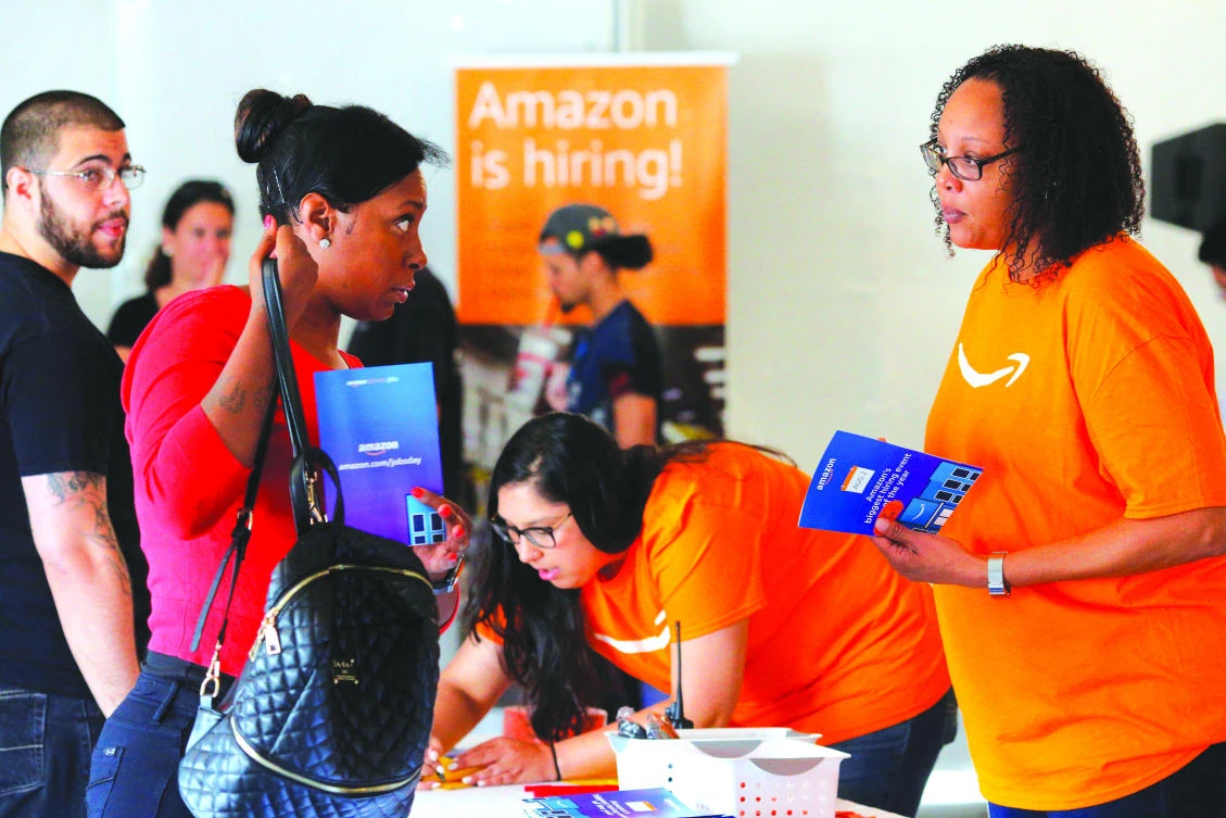 Potential job applicants register for ‘Amazon Jobs Day,’ a job fair being held at 10 warehouses across the US aimed at filling more than 50,000 jobs, at the Amazon.com Fulfillment Center in Fall River, on Wednesday. (Reuters)