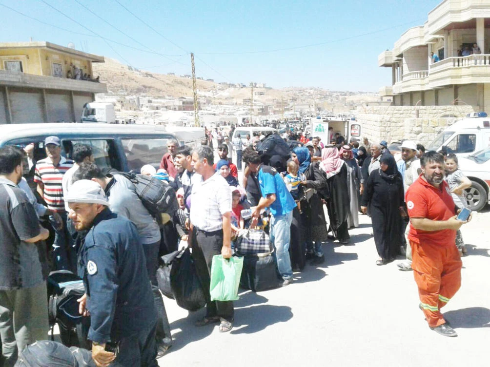 A convoy of nearly 200 vehicles carrying Jabhat Fateh Al-Sham (JFS) militants and their families leaving Lebanon for rebel-held Idlib in Syria. (AN photo by Najia Houssari)