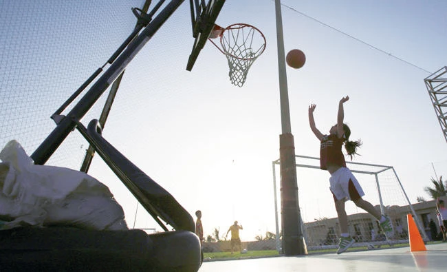 In this May 12, 2014 file photo, a girl shoots baskets during team practice at a private sports club in Jeddah, Saudi Arabia. (AP)