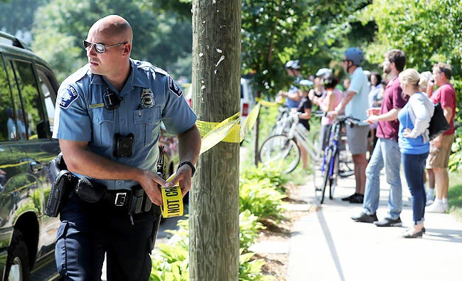 A Minneapolis police officer puts up police tape following an explosion at Minnehaha Academy on Wednesday, in Minneapolis. (AP)