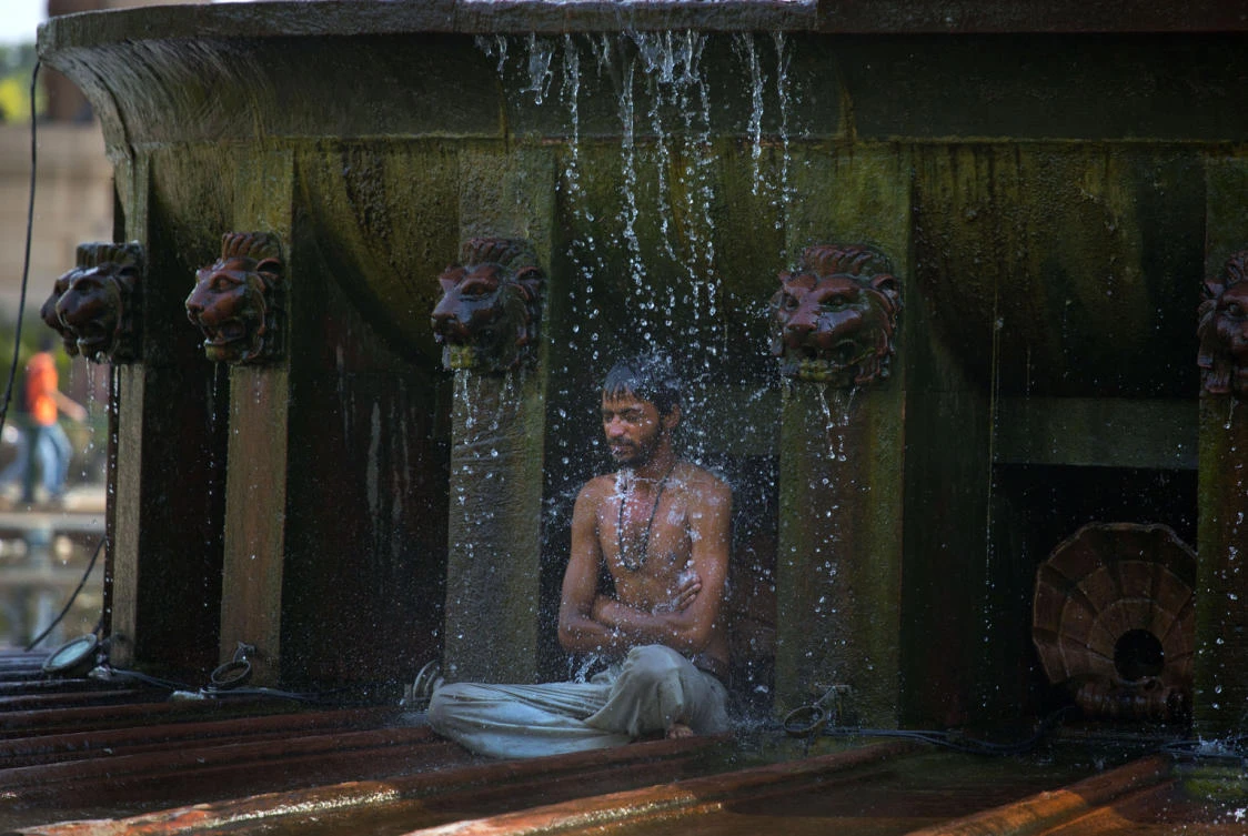 FILE- In this May 2, 2016 file photo, an indian man cools himself under a public fountain on a hot afternoon in New Delhi, India. A new study suggests wide swaths of northern India, southern Pakistan and parts of Bangladesh may become so hot and humid by the end of the century it will be deadly just being outdoors. Such conditions would threaten up to a third of the 1.5 billion people living in those regions, unless the global community can rein in climate-warming carbon emissions. (AP)
