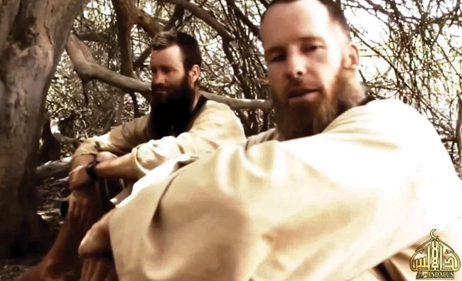 Hostages Johan Gustafsson of Sweden, left, and Stephen Malcolm McGown of South Africa, speaking with their captors on camera at an unknown location in Mali in this file photo. (AFP)