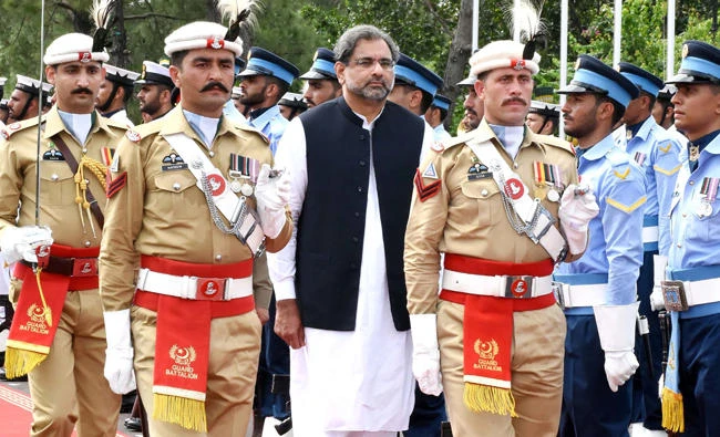 Pakistan's Prime Minister Shahid Khaqan Abbasi, center reviews the honor guard during a welcome ceremony at the Prime Minister House in Islamabad on Thursday. (AFP)