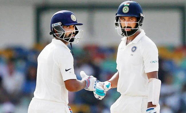 India’s Cheteshwar Pujara and Ajinkya Rahane celebrate their partnerhip. (Reuters)