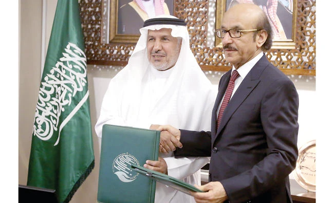 Abdullah Al-Rabeeah, left, KSRelief supervisor general, and Mahmoud Fikri, director of the WHO’s Eastern Mediterranean office, shake hands after signing a deal to combat cholera in Yemen. (AN photo by Saad Al-Dosary)