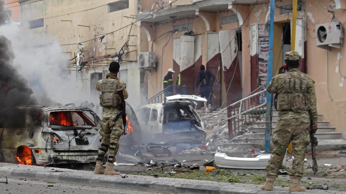 Somalian security personnel look towards burning vehicles as they secure an area in Mogadishu on July 30, 2017, after a car bomb explosion in the Somalian capital. (AFP)