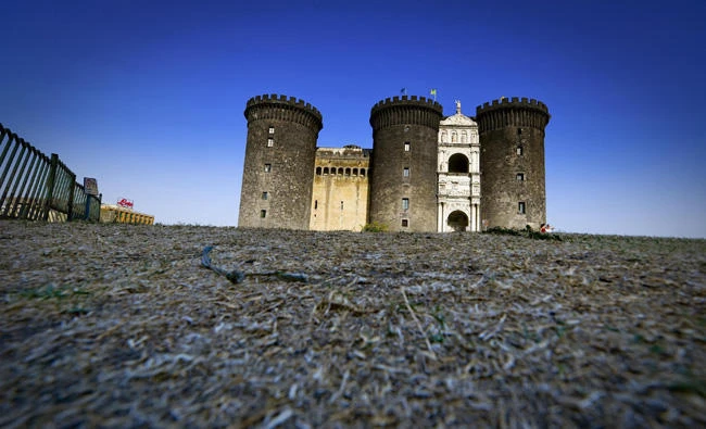 The lawn in front of the ''Maschio Angioino'' castle is completely dried out and turned hay by the heat, in Naples, Italy, on Thursday. (Ciro Fusco/ANSA via AP)