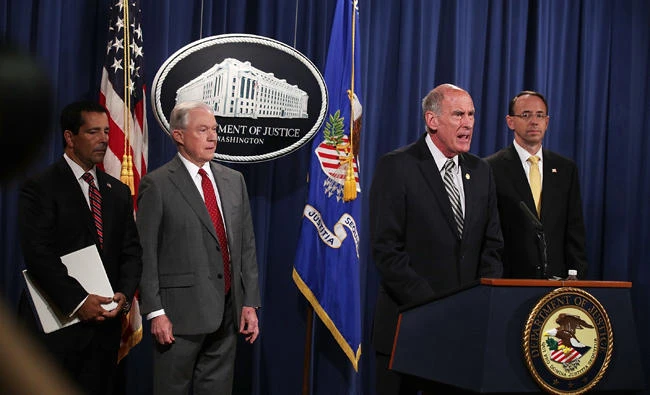 US Director of National Intelligence Dan Coats (3rd L) speaks as Attorney General Jeff Sessions (2nd L), Deputy Attorney General Rod Rosenstein (R) and National Counterintelligence and Security Center Director William Evanina (L) listen during an event at the Justice Department on Friday in Washington, DC. (Alex Wong/Getty Images/AFP)