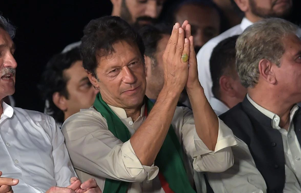 Pakistani opposition leader and head of the Pakistan Tehreek-i-Insaf (PTI) party Imran Khan speaks to supporters during a rally in Islamabad on July 30, 2017. Pakistan’s new prime minister on Friday endorsed a parliamentary investigation into allegations of sexual harassment leveled by a female lawmaker against Khan and his supporters. (AFP / AAMIR QURESHI)