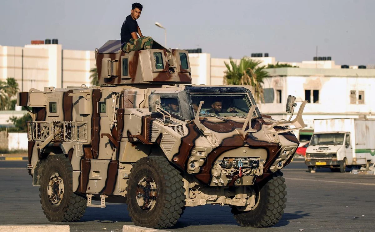 Members of the self-styled Libyan National Army, loyal to the country's east strongman Khalifa Haftar, ride in and atop an armored vehicle in the eastern city of Benghazi on July 27, 2017. (AFP file photo)