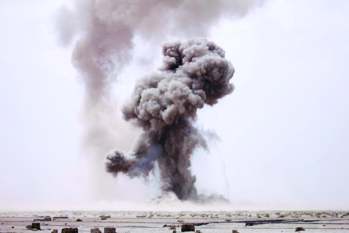 Smoke billows during controlled explosions by a Yemeni military demining unit to destroy unexploded bombs collected from conflict areas near Aden. (Reuters)
