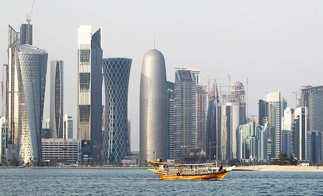 In this Jan. 6, 2011 file photo, a traditional dhow floats in the Corniche Bay of Doha, Qatar, with tall buildings of the financial district in the background. (AP)