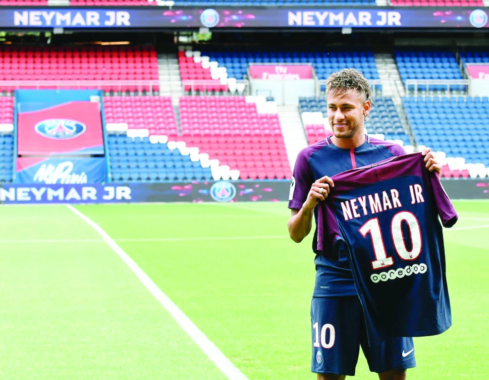 Brazilian superstar Neymar displays his new jersey during his official presentation at the Parc des Princes stadium in Paris on Friday. (AFP)