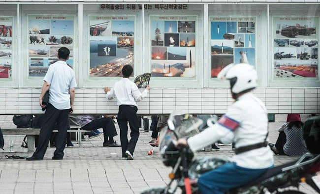 People look at a display showing images of missiles launches and military exercises in a public square in Pyongyang, in this July 29, 2017 photo. (AFP)