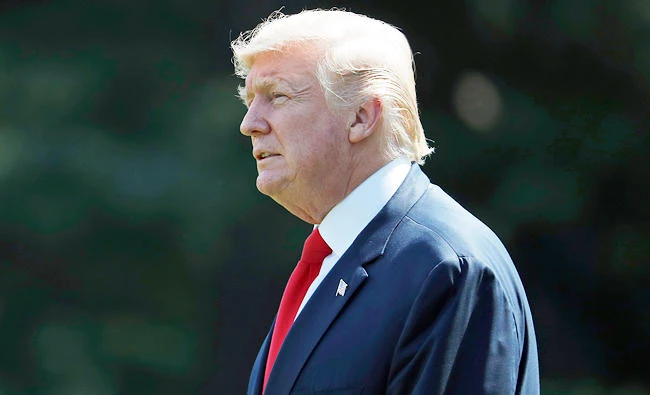 President Donald Trump walks to Marine One on the South Lawn of the White House in Washington, on Friday, for a short trip to Andrews Air Force Base, Md. en route to Bedminster, N.J., for vacation. (AP)