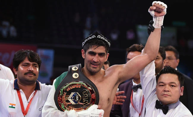 Indian boxer and WBO Asia-Pacific Super Middleweight champion Vijender Singh (C) celebrates after winning the double title bout against China's Zulpikar Maimaitiali at the National Sports Complex of India (NSCI) Dome in Mumbai on Saturday. (AFP / Punit Paranjpe)