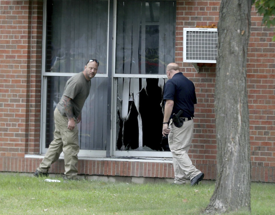 Law enforcement officials investigate an explosion at the Dar Al-Farooq Islamic Center in Bloomington, Minn., on Saturday, Aug. 5, 2017. Bloomington police Chief Jeff Potts said Saturday that investigators are trying to determine the cause of the blast. Authorities say the explosion damaged one room but it didn't hurt anyone. (David Joles/Star Tribune via AP)