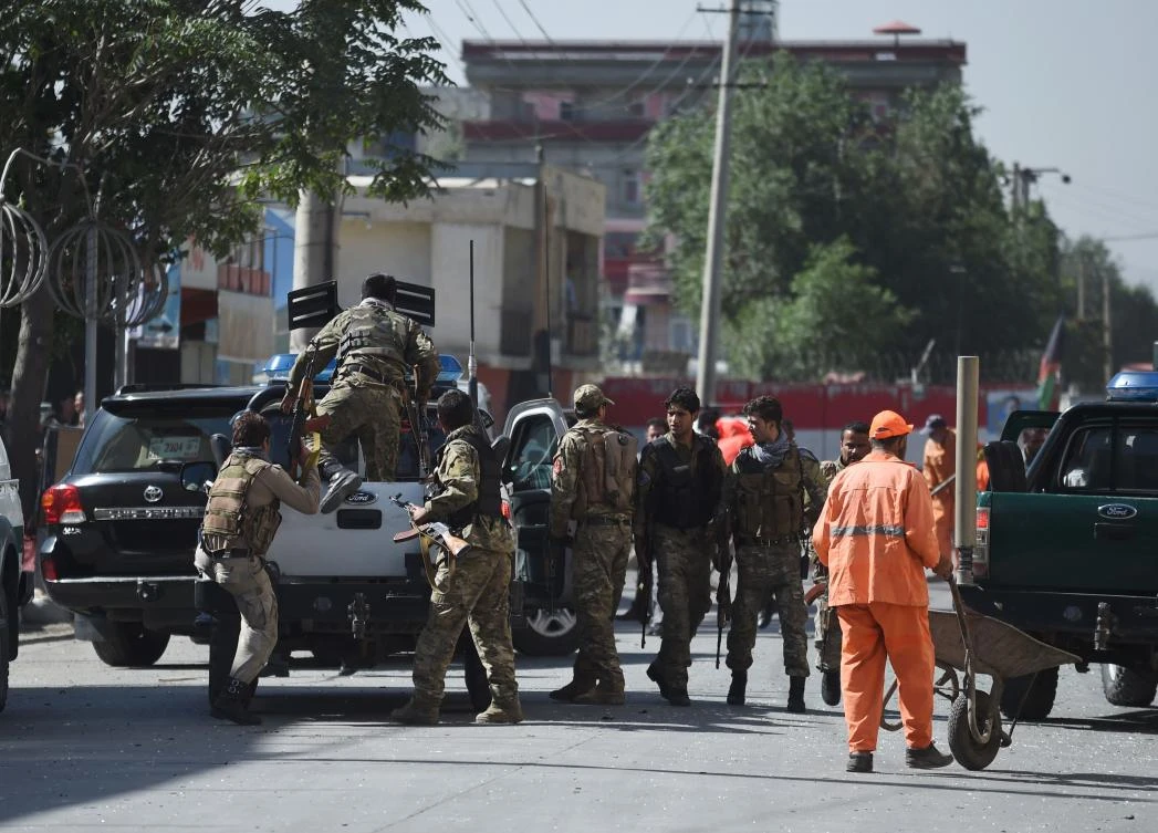 Afghan security personnel leave the site of a car bomb attack in western Kabul on July 24, 2017. At least 24 people have been killed and 42 wounded after a car bomb struck a bus carrying government employees in western Kabul on July 24, an official told AFP, the latest attack to strike the Afghan capital. (AFP)
