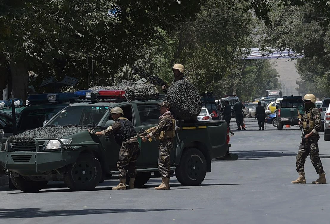 Afghan members of the National Directorate of Security (NDS) keep watch at the site of a suicide blast near Iraq's embassy in Kabul on July 31, 2017. A series of explosions and the sound of gunfire shook the Afghan capital on July 31, with a security source telling AFP that a suicide bomber had blown himself up in front of the Iraqi embassy. "Civilians are being evacuated" from the area as the attack is ongoing, said the official, who declined to be named. / AFP / SHAH MARAI