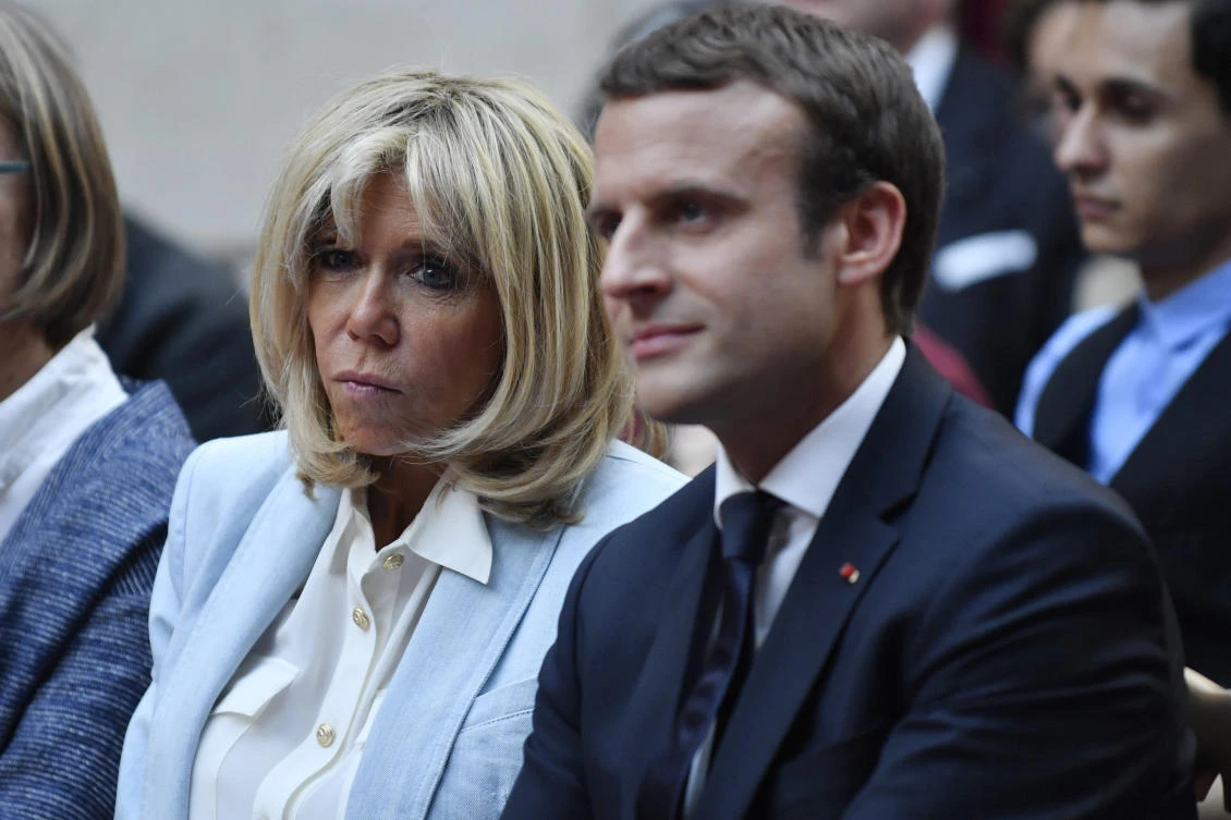 In this photo dated Tuesday, July 25, 2017, French First Lady Brigitte Macron and French President Emmanuel Macron attend a concert from the Pierre Claver association at the Elysee Palace in Paris, France. (Julien de Rosa/Pool Photo via AP)