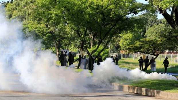 Venezuelan Bolivarian National Guard officers fire teargas at protesters trying to march toward a military base in Valencia, Venezuela, on Aug. 6, 2017. (AP)