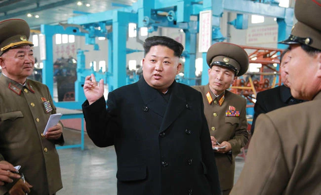 This undated photo released from North Korea's official Korean Central News Agency (KCNA) on April 1, 2015 shows North Korean leader Kim Jong-Un (C) inspecting the machine plant managed by Jon Tong Ryol at an undisclosed location in North Korea. (AFP)