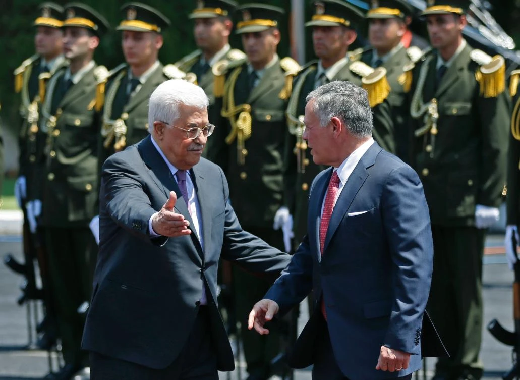 Jordan’s King Abdullah II (R) speaks with Palestinian president Mahmud Abbas (L) upon his arrival in the West Bank city of Ramallah on August 7, 2017. (AFP)