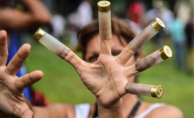 An anti-government activist shows bullet cases during a protest in Valencia, Venezuela, on Sunday. (AFP)