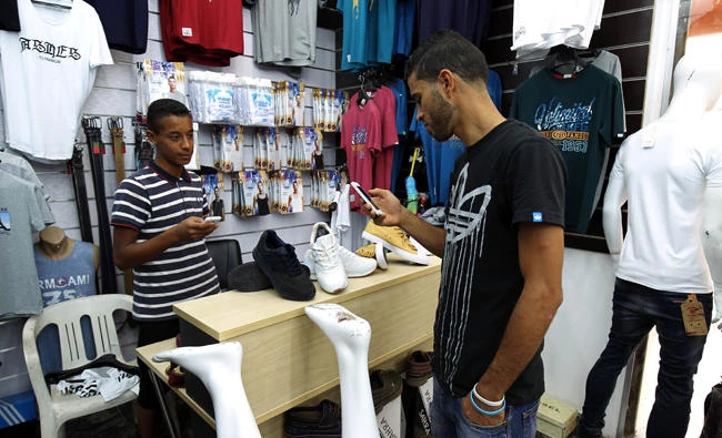 A man uses a mobile phone app to pay at a store in Benghazi, Libya. (AFP)
