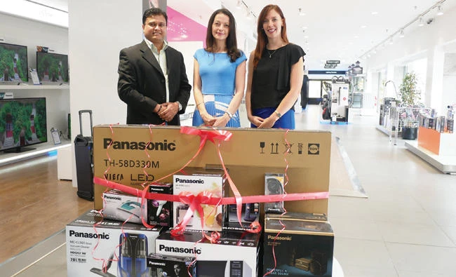 Maura Hales, center, with representatives from Panasonic and Al-Futtaim Panatech.