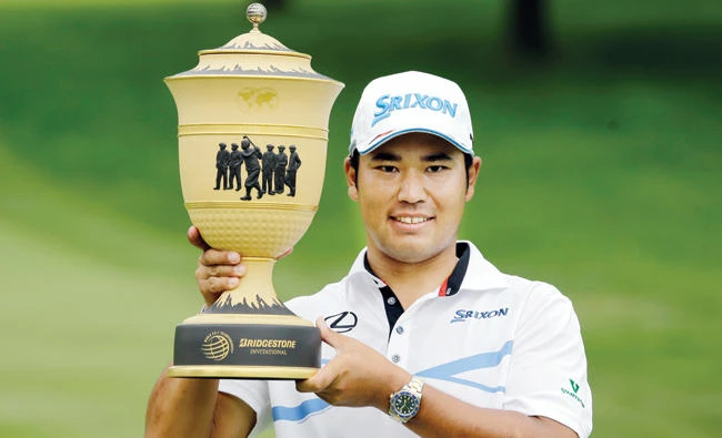 Hideki Matsuyama, from Japan, holds up The Gary Player Cup trophy after the final round of the Bridgestone Invitational golf tournament at Firestone Country Club Sunday. (AP)