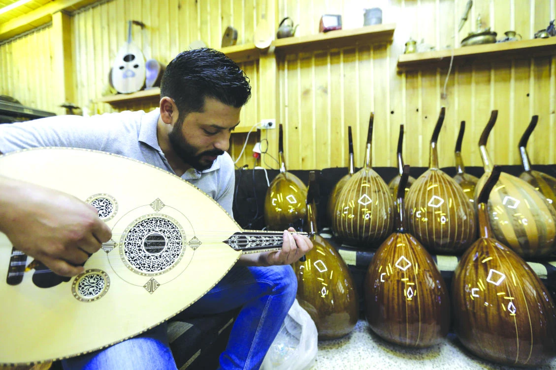 Ali Khalifeh, a lute-maker, tries an oud at a shop in the Syrian capital Damascus. The first Damascene oud was produced in 1897 by Abdo Al-Nahhat, who became one of the country’s most renowned lute-makers. (AFP)